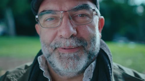 Portrait of Mature Man with Gray Beard Outdoors in the Park