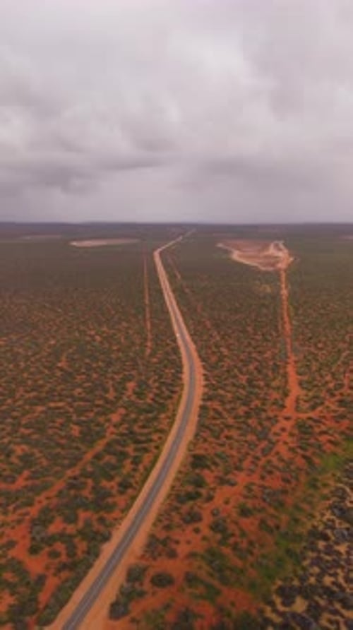 Aerial view of desert road in rugged landscape, Australia.