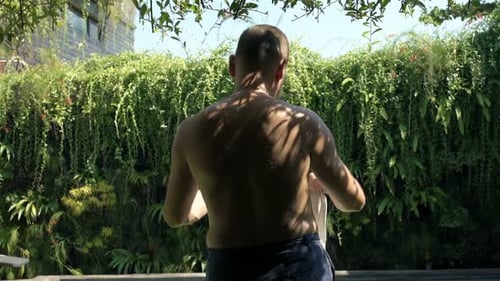 Relaxed Man Walking into Summer Garden