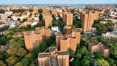 Beautiful neighborhood with plenty of greenery. Drone footage above the brick multi-storied building