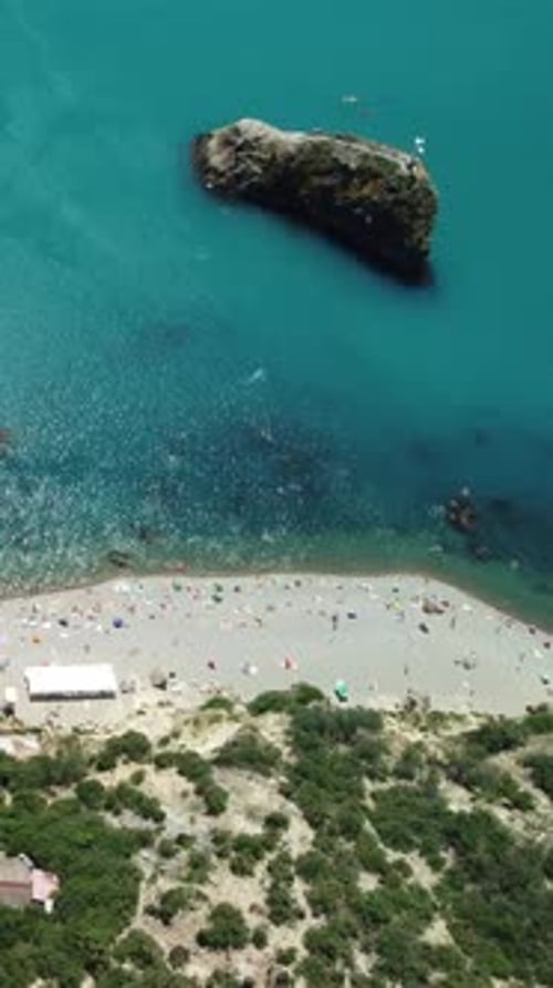 Aerial View on Summer Beach Swimming People in Sea Bay with Transparent Blue Water and Volcanic