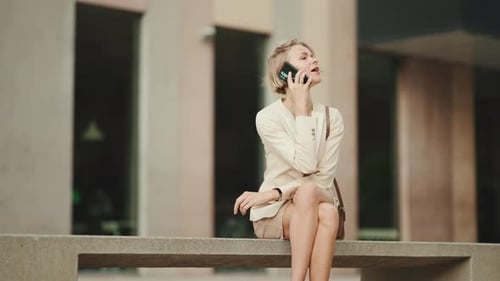 Woman Makes a Phone Call Outdoors