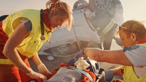 Paramedics tending to a patient after car accident