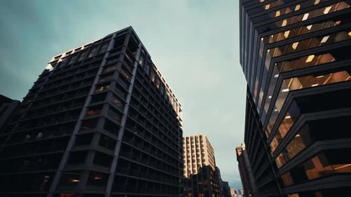 Edificios urbanos altos bañados por una luz cálida durante el crepúsculo con calles concurridas debajo