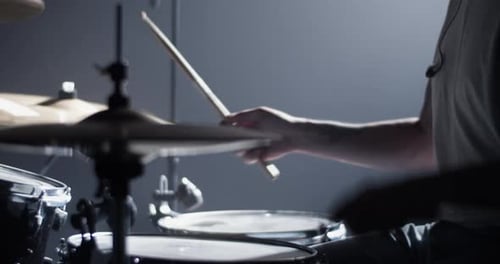 Unrecognizable Musician Playing Drums with Drumsticks in Club
