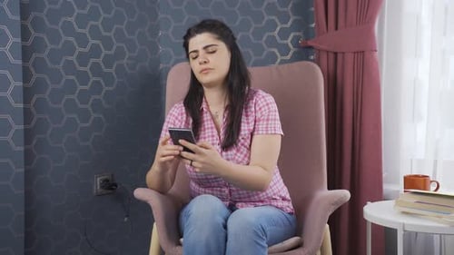 Woman Relaxing with Smartphone at Home