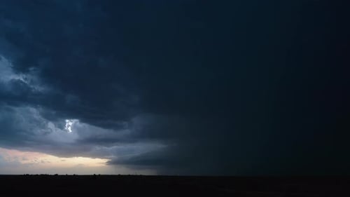 Dramatic storm clouds and sunset over rural landscape