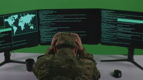 Back View Of Man Soldier Having Headache While Write Code With Multiple Screens In Green Screen