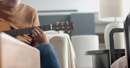 Man Plays Guitar in Living Room