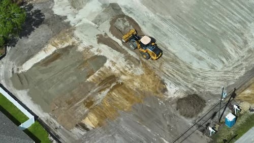 Earth Moving Tractor Preparing Place for Future House Foundation Construction Leveling Soil for