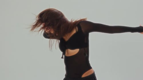 Girl In Black Dancing Solo In Clean White Studio Space