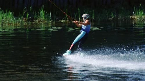 Sport Woman On Board Sliding On Water. Girl Studying Wakeboarding On Lake. Water Boarder Wakeboar...