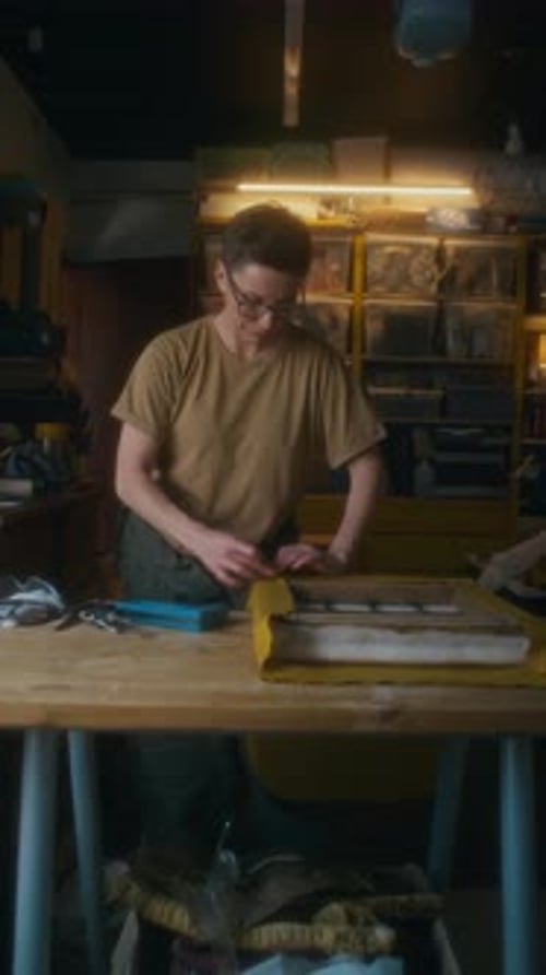 Person Working on Frame in Workshop, Medium Shot