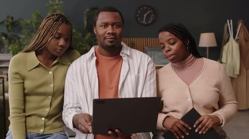 Portrait of Creative Black Team with Laptop in Green Office
