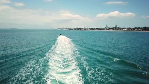 Motorboat Speeding Through Open Sea in Daytime