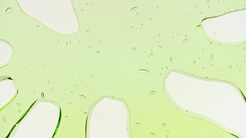Transparent Green Cosmetic Gel Fluid With Molecule Bubbles and Oil on White Background