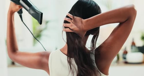 Woman Dries Hair with Hair Dryer at Home