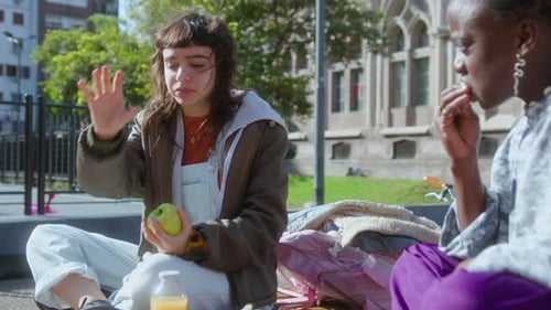 Two College Girls Chatting on Campus Picnic