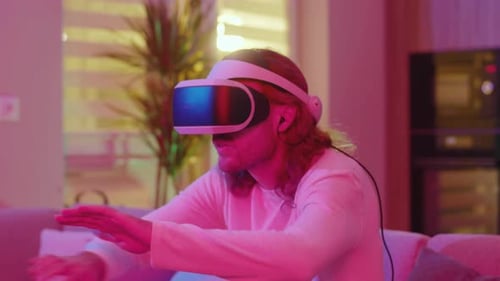Young Adult Immersed in Virtual Reality at Home