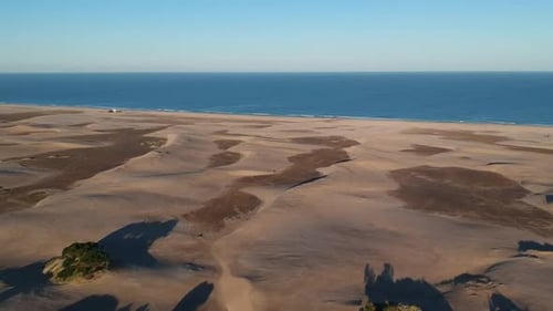 Aerial View of Sand Dunes Meeting the Ocean
