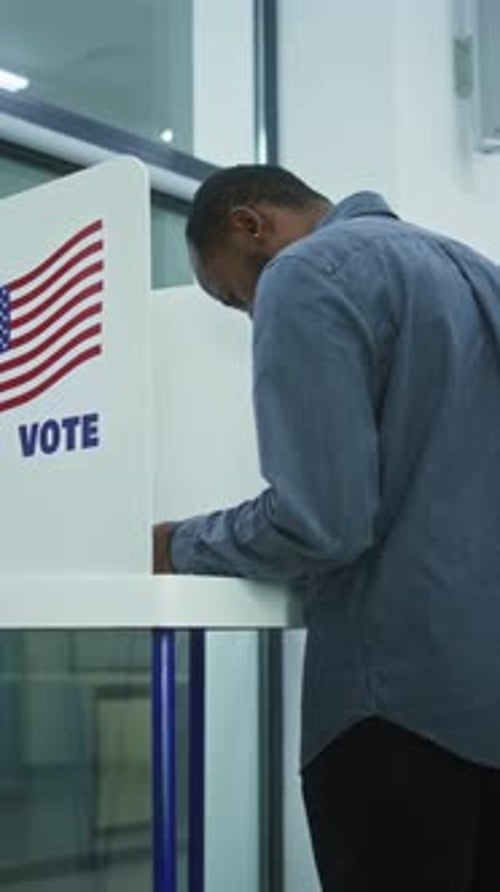 Diverse American Citizens Vote in Booths in Polling Station Office