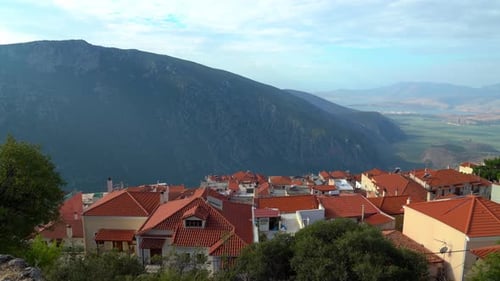 Ancient City of Delphi and Modern Red Tile Rooftop Houses
