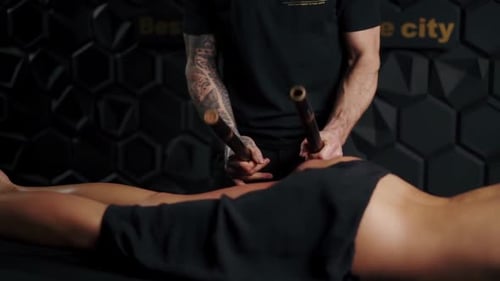 Woman Receiving a Luxurious Bamboo Massage Treatment