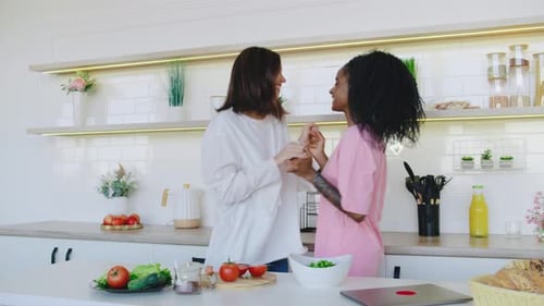 Friends Dancing in Kitchen, Embracing with Joy