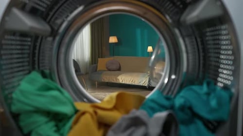 View From Inside the Washing Machine Young Man with Cleanser Walks Into Room