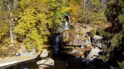 View of Waterfall on Large Stone Boulders Park Sunny Autumn Day Public Park Lake