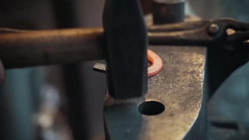 Blacksmith Shaping Glowing Horseshoe on Anvil