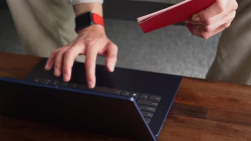 Closeup View of Male Hands Typing on Keyboard of Laptop His Personal Information From Passport