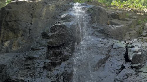 Closeup Slow Motion Shot of Small Waterfall in the Tropical Rainforest Jungle of Philippines Small