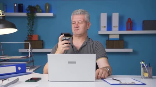 Home office worker sprays perfume on man.