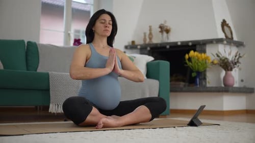 Pregnant Woman Doing Yoga in Bright Living Room