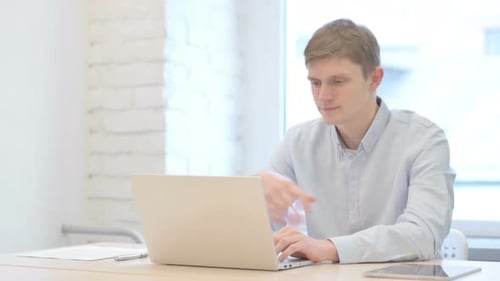Young Adult Man on Video Conference at Work