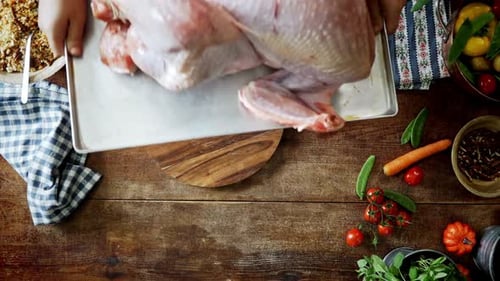 Raw Turkey Placed on Table with Ingredients
