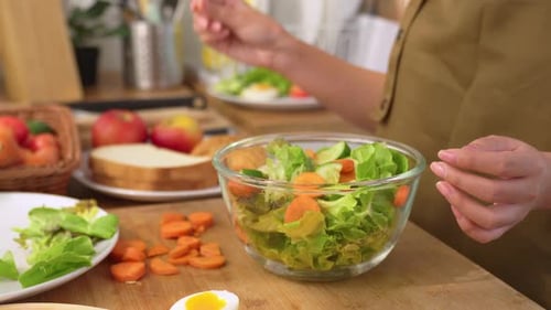 Close up of woman cooking healthy foods in kitchen in morning at home.