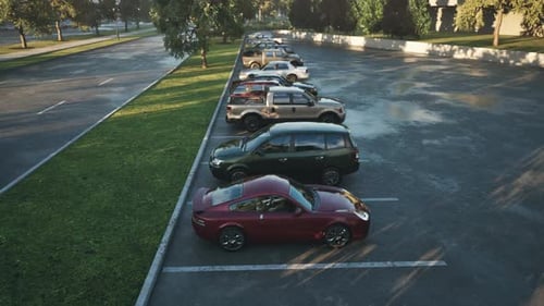 Cars Parked in a Sunny Lot Near Trees on a Calm Afternoon