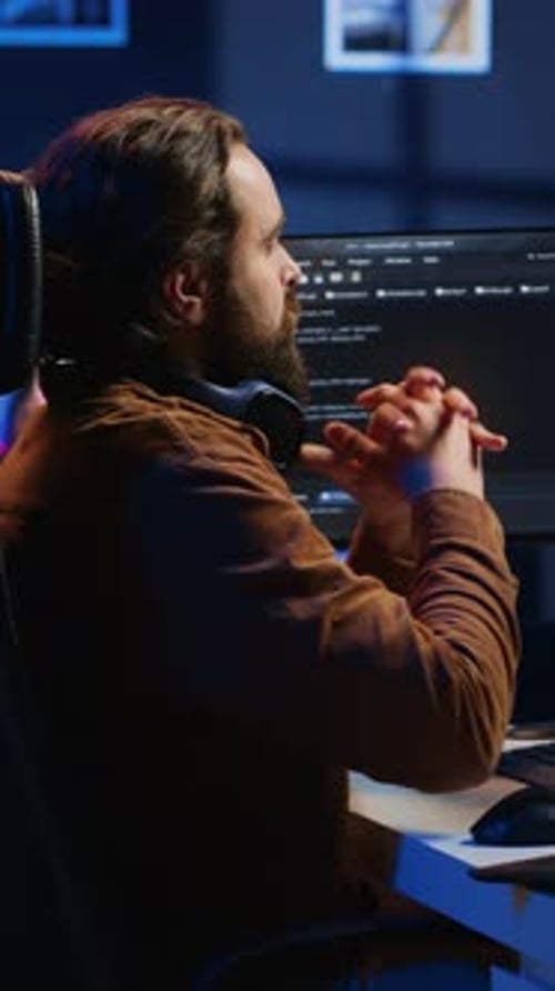 Programmer Removing Headphones to Better Concentrate on Difficult IT Task