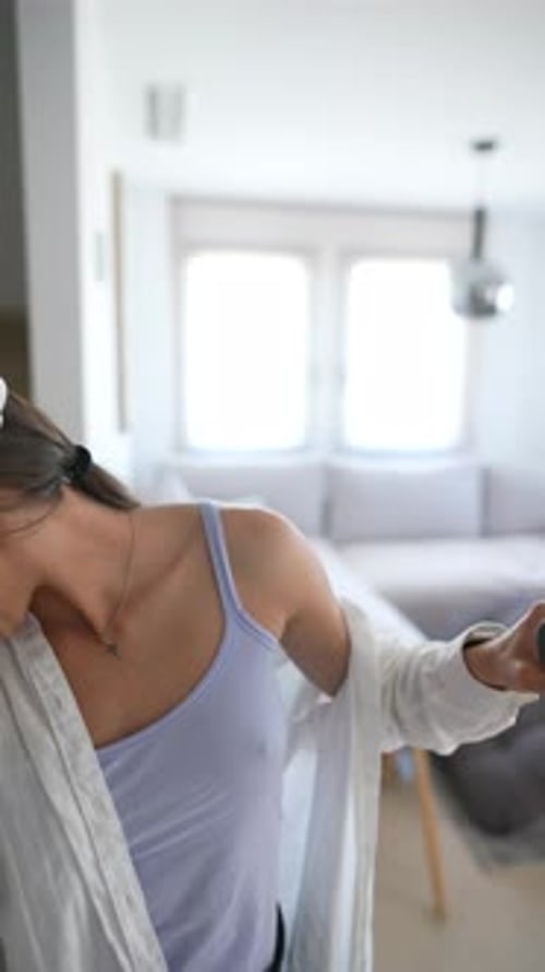 Woman Immersed in Virtual Reality Gaming at Home