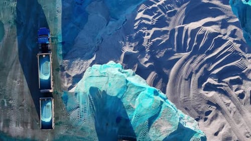 Blue salt mound being loaded into trucks from above at Detroit salt facility in America