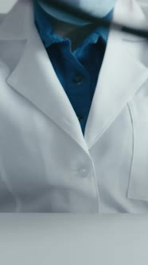 Medical Professional in Gloves at Desk