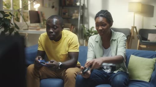Friends Enjoying Video Games on Couch in Living Room