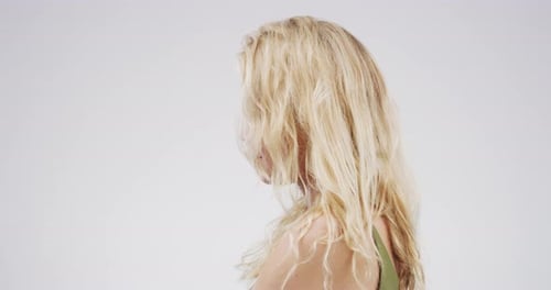 4k video footage of a stressed out young woman standing against a grey background