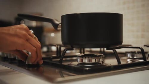 Turning On Gas Stove and Cooking Pot in Kitchen