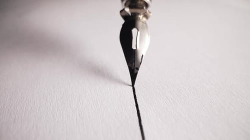 Macro of Fountain Pen Nib Writing Straight Ink Line On Textured Paper Surface
