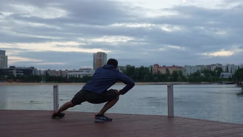 Wide Rear View Shot of Unrecognizable Sporty Man Preparing and Warming Up Body Before Doing Training
