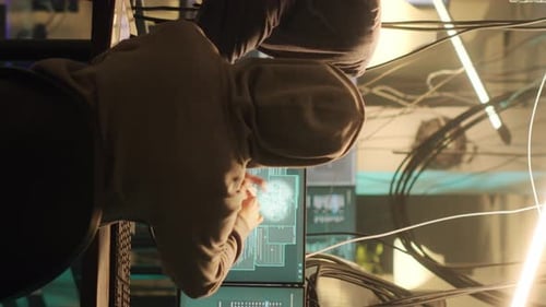 Hooded Coder Working at Night