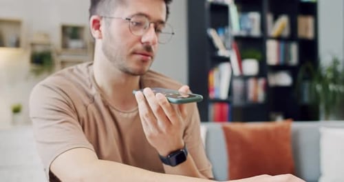 Man Typing and Talking Into a Mobile Phone